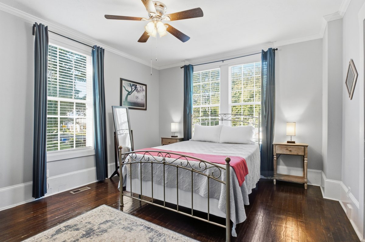 Bedroom with iron bed and windows